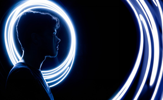Wireframe human profile face portrait on blue, technological background. Circle light painting, Man silhouette