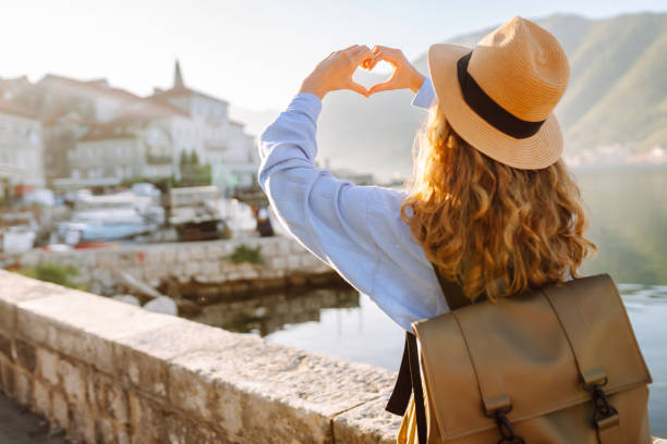 istock Happy young woman showing heart shaped hands. 2030474159