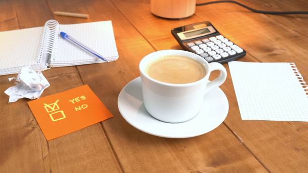 A man serves coffee on a wooden table.