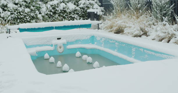 istock A swimming pool preserved for the winter is covered with snow. 2030510298