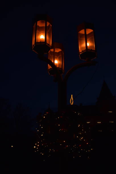 istock three old street lamps and a a candle 2030522670