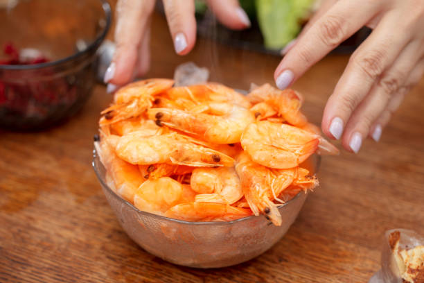 istock Hands and hot shrimp with smoke. 2030525371