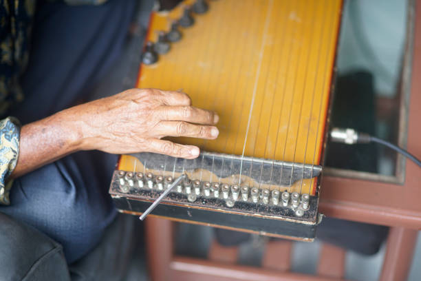 istock old man's hand plays kecapi. original Indonesian musical instruments 2030544277