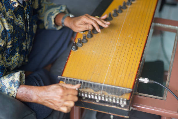 istock parents are tuning kecapi. original Indonesian musical instruments 2030545395
