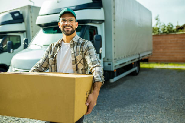 istock Young handsome truck driver carrying package. 2030552233