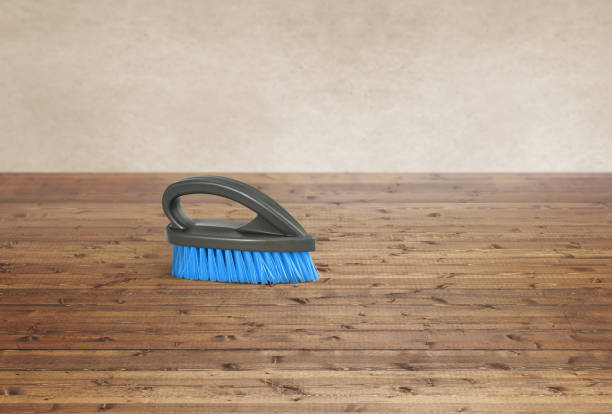Cleaning brush on a wood floor background
