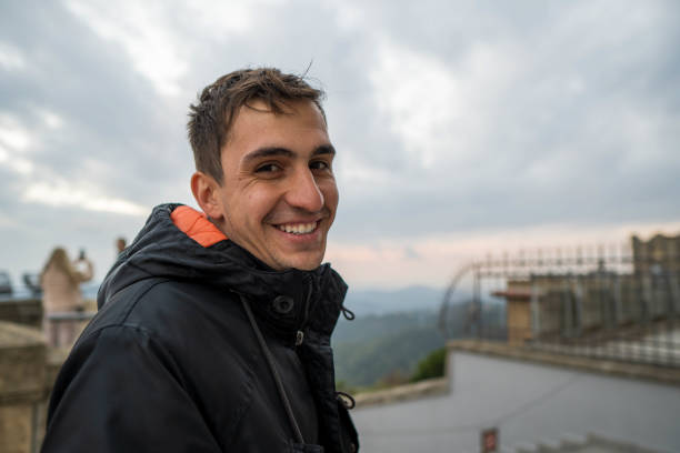 istock Brunet young man looking at camera in winter with a naughty face 2030563978