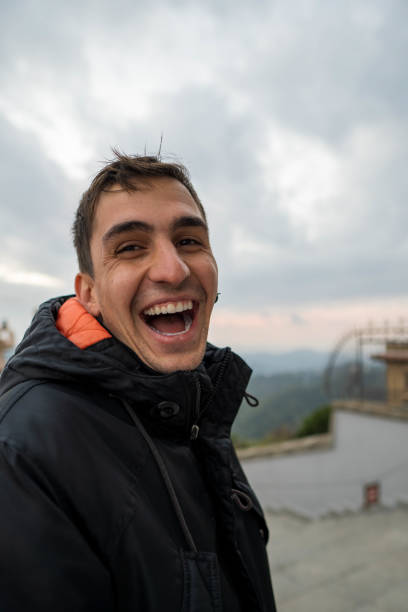 istock Young brunet man in jacket laughing out loud. Vertical 2030563987