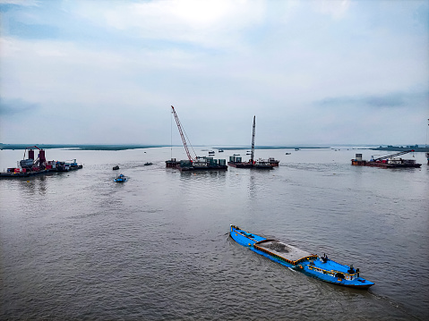 Floating boat carrying sand in river way named jamuna