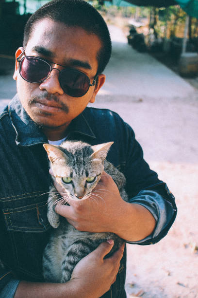 istock scary man play with cat 2030585811