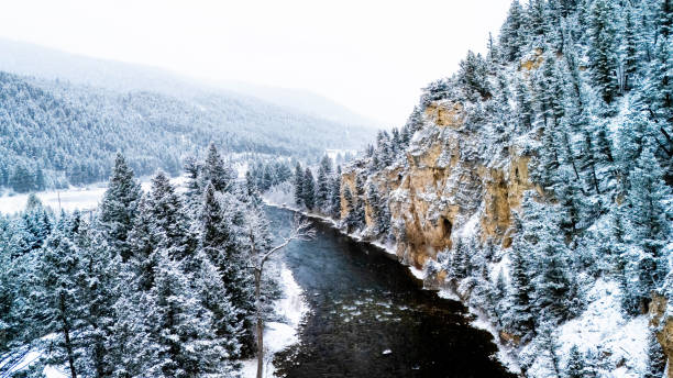 Snow covered mountains canyon through the river road aerial view