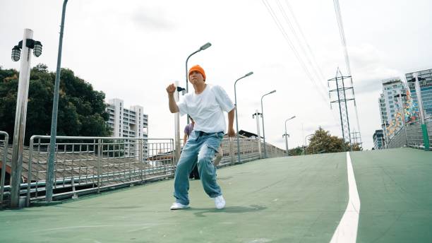 istock Professional asian hipster walking while doing freeze pose at bridge. Sprightly. 2030596471