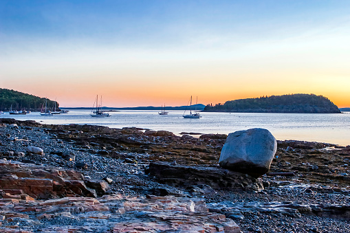 Sunrise on the Atlantic Ocean, islands and rocky Maine Coast in Bar Harbor Desert Island, USA.