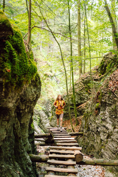 istock Smiling woman walking with backpacks in woods. 2030641085