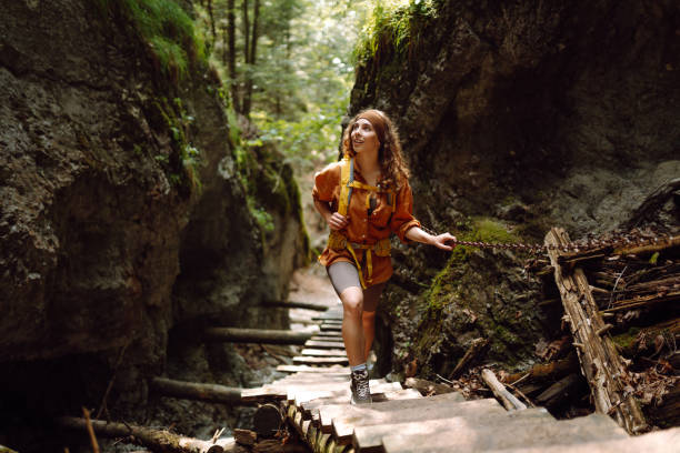 istock Smiling woman walking with backpacks in woods. 2030641107
