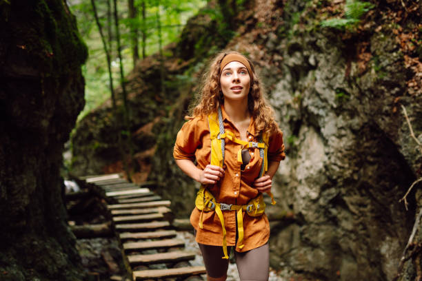istock Smiling woman walking with backpacks in woods. 2030641108