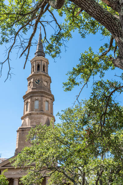 istock Clock tower rises above a park with lush trees in Charleston, Boston 2030649083
