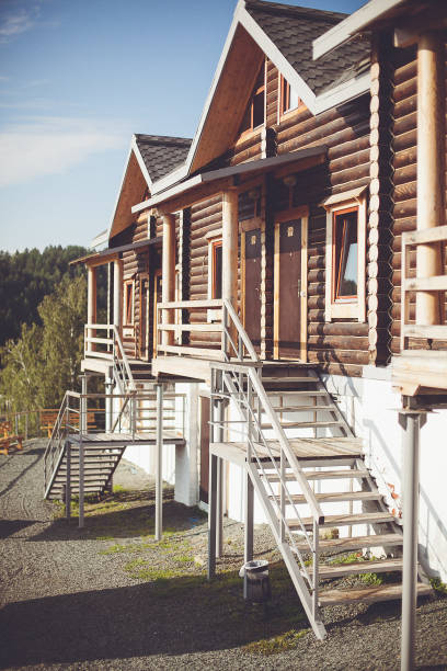 istock a row of log cabins with stairs leading up to them 2030652409