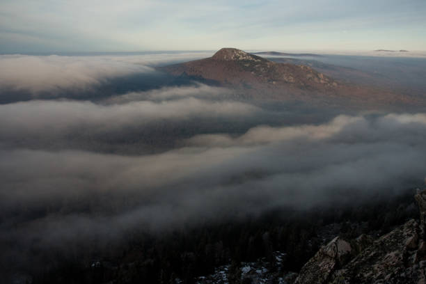 Cloudcovered mountain viewed from the highlands creating a mystical atmosphere