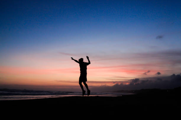 silhouettes of people jumping up and down one hand