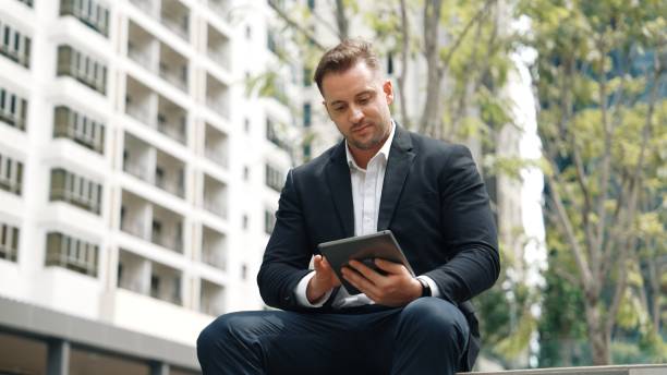 istock Professional business people working tablet while sitting at green city. Urbane. 2030664263