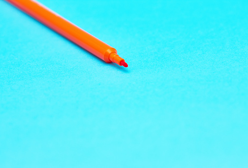 Close-up of an orange felt-tip pen.