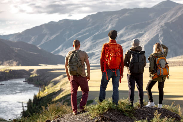istock Group of hikers with backpacks are standing in mountains 2030669699