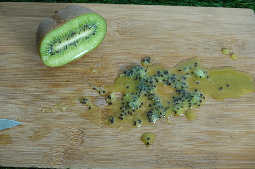 board with halved kiwi fruit to obtain fruit seeds for sowing