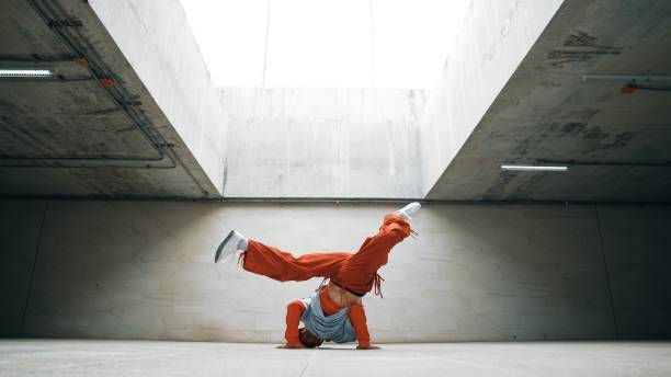 dancing man enjoy practice break dance or freestyle in building. sprightly. - breakdancing stock-fotos und bilder