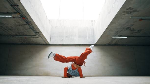 Dancing man enjoy practice break dance or freestyle in building. Sprightly. Happy dancing man enjoy practice break dance or freestyle dance in building. Professional b-boy dancer perform energetic movement or doing freeze pose modern life style. Outdoor sport 2024. Sprightly. breakdance stock pictures, royalty-free photos & images