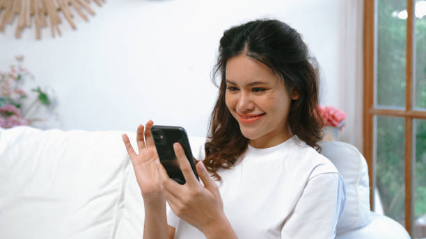 istock Young woman using smartphone browsing for online shopping E commerce by online payment gateway at vivancy home. Modern and convenience online purchasing make secure and convenient purchases. 2030729339