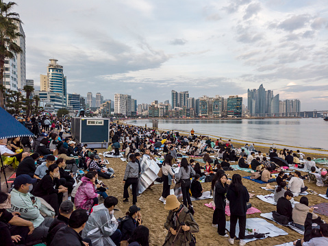 busan, south korea - november 4, 2023: people waiting at gwangalli beach for the famous fireworks festival in busan, future expo 2030 city in south korea
