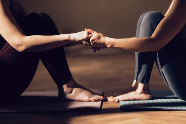 istock Close-up of Two People Practicing Partner Yoga in a Serene Setting 2030735196