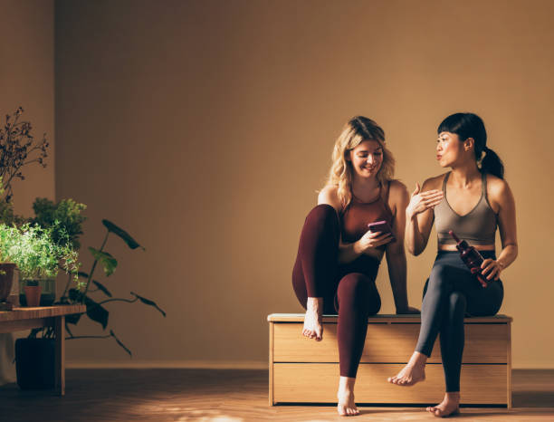 istock Two Friends in Activewear Sharing a Conversation Indoors 2030735228