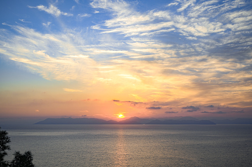 Sunset over sea and mountain landscape