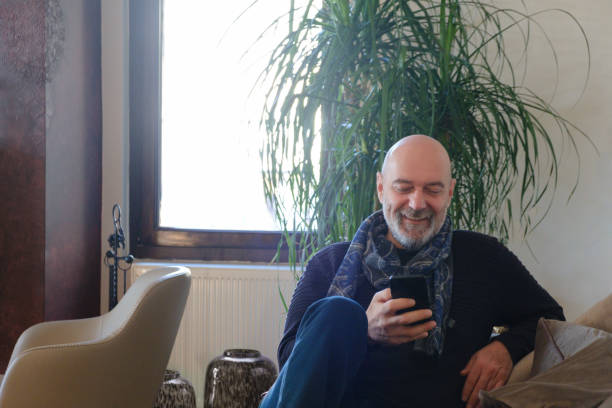 istock Man relaxing at home and using phone 2030798628