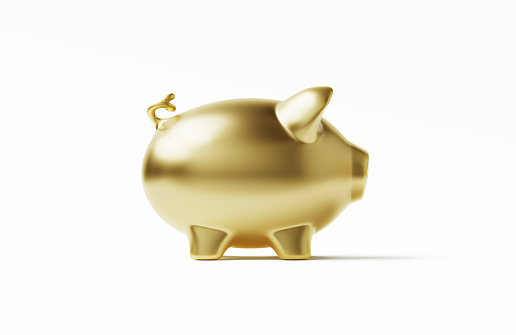 Gold colored piggy bank on white. Horizontal composition.