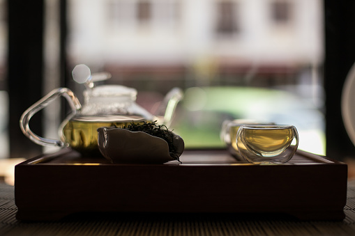 Serveware on wooden tray, tea set displayed in still life photography