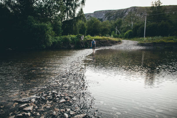 istock a man is crossing a river on a bridge 2030829735