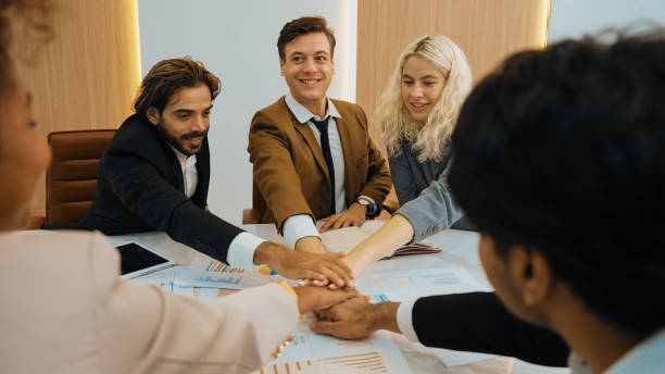 istock Group of diverse office worker join hand together in ornamented office room 2030860140