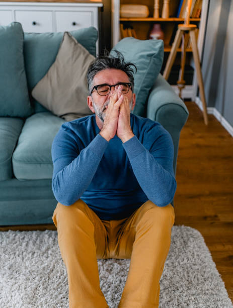 istock Depressed man sitting alone on the floor 2030864884
