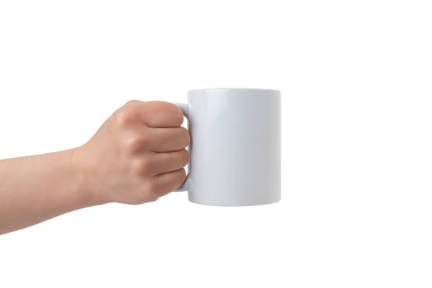 istock Clean white mug, held by an isolated hand, offers a perfect canvas for Print-on-Demand design promotion. Customizable and versatile 2030867501