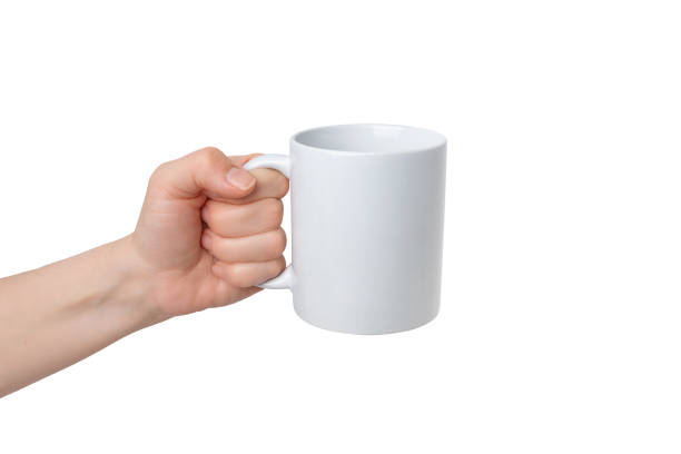 istock Isolated hand holds a blank white mug, ready for Print-on-Demand design promotion. Versatile, customizable, and ideal for showcasing personalized creations 2030867502
