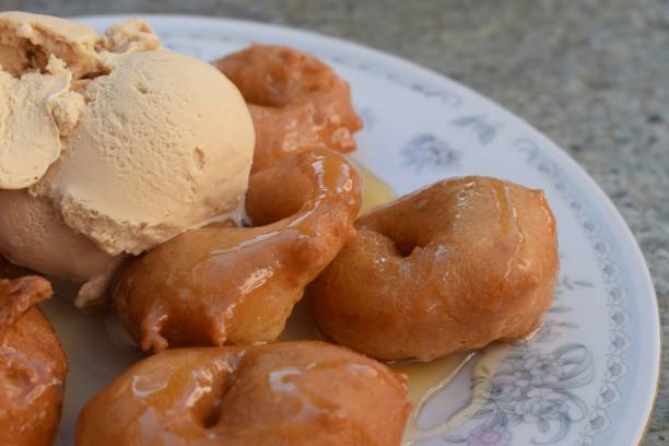 istock Traditional Greek loukoumades donuts with honey and ice cream 2030877022