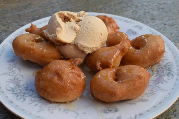 istock Traditional Greek loukoumades donuts with honey and ice cream 2030877061
