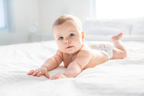 istock Adorable baby boy in white sunny bedroom. 2030878135