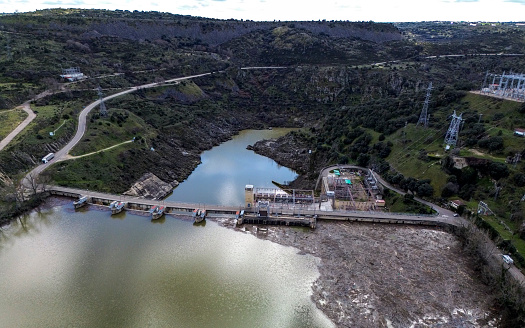 Road over the hydroelectric dam of the Villalcampo waterfall, Duero river, Castilla y León, Spain.
