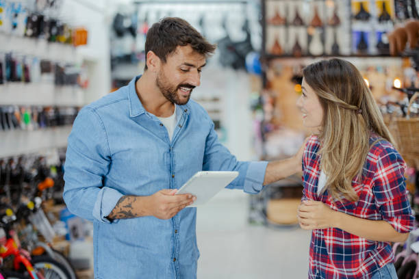 istock Bicycle Salesman Using Digital Tablet and Talking with Customers 2030900584