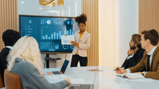 Presentation in office or ornament meeting room with analyst team Presentation in office or ornament meeting room with analyst team utilize BI Fintech to analyze financial data. Businesspeople analyzing BI dashboard power display on TV screen for strategic planning bi black stock pictures, royalty-free photos & images