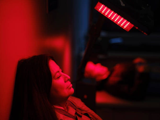 istock Woman On an LED Bed Receiving Red Light Therapy 2030956390